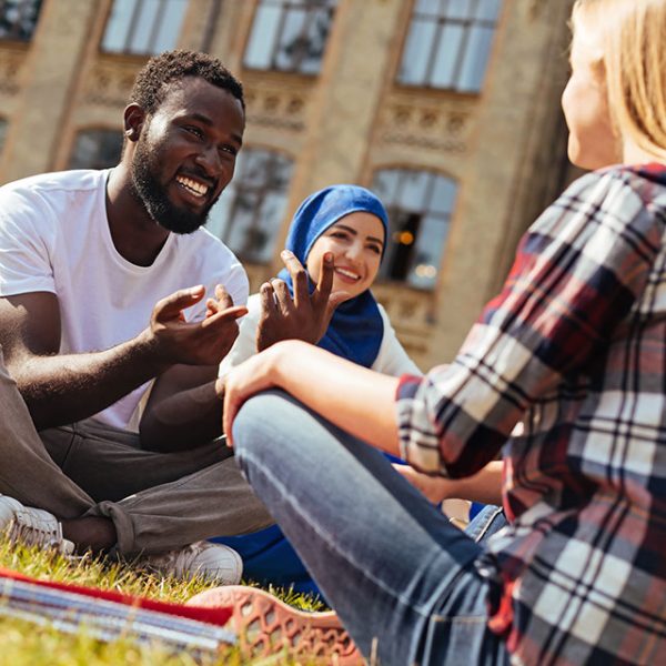 Diverse students sitting on campus