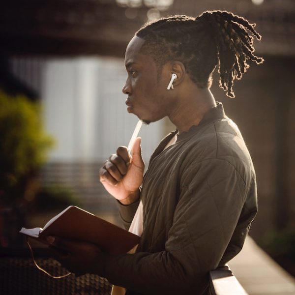 African American Student Holding a book and thinking about something